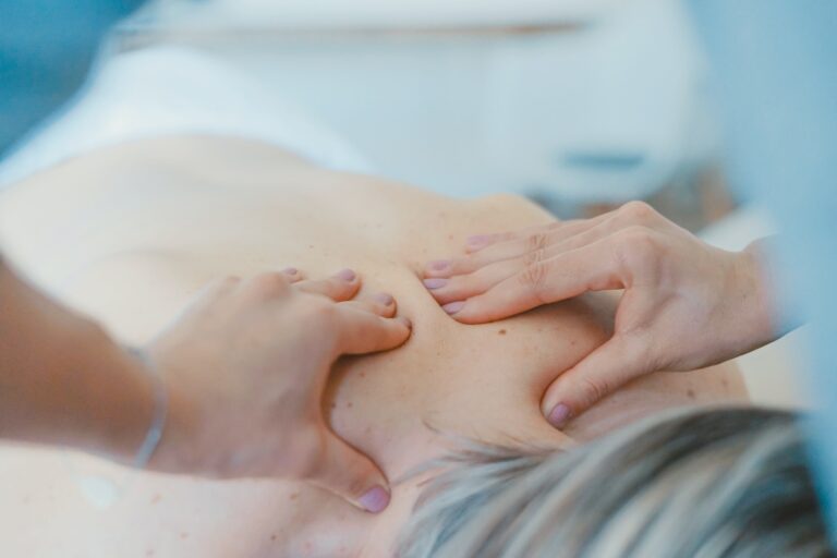 a lady giving a swedish massage to someone on a table