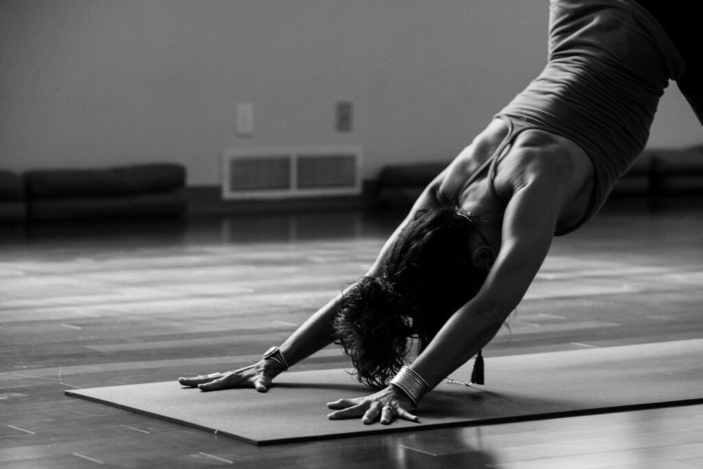 lady doing yoga on a mat in a yoga studio